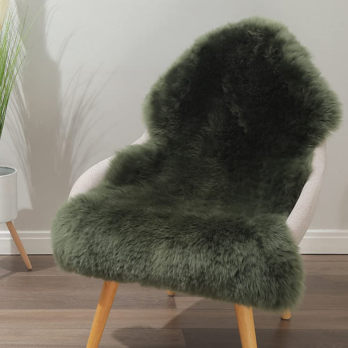 Forest green faux sheepskin area rug with fluffy high-pile texture, styled as a chair throw for aesthetic home decor.