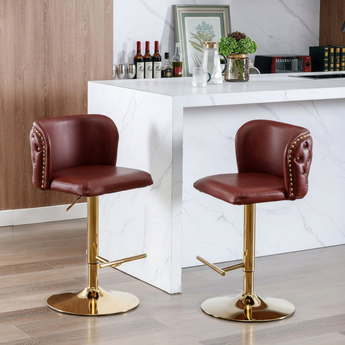 Set of 2 burgundy faux leather swivel bar stools with gold chrome bases and tufted backrest for modern kitchen island seating.